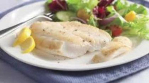 cooked orange roughy with side salad and lemon