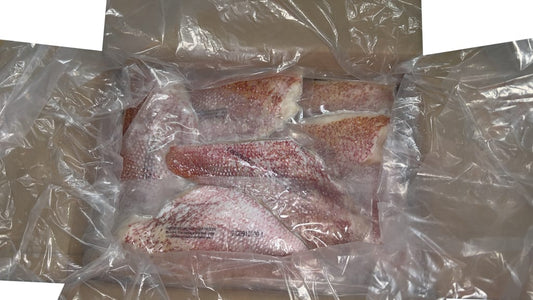 Skin on Red emperor fillets individually vacuum packed in carton on white background