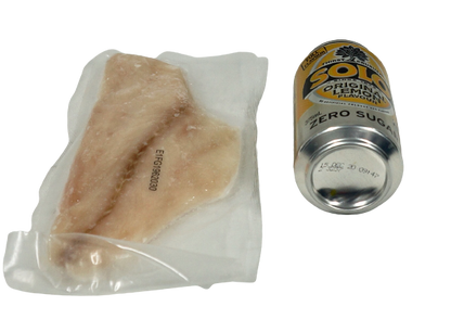 individual emperor fillet in vacuum pack next to can of drink no background