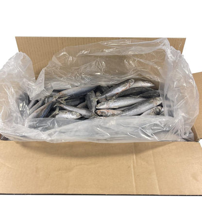 Open carton with an open plastic bag containing round scad on a white background