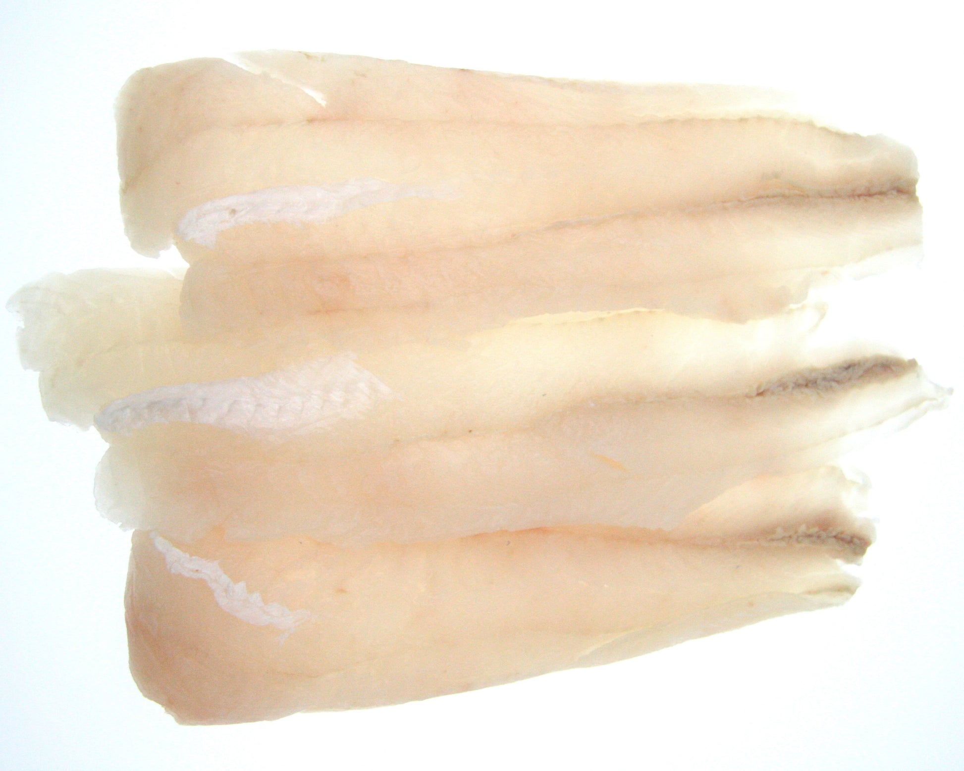 A stack of skinless hoki fillets against a white background.